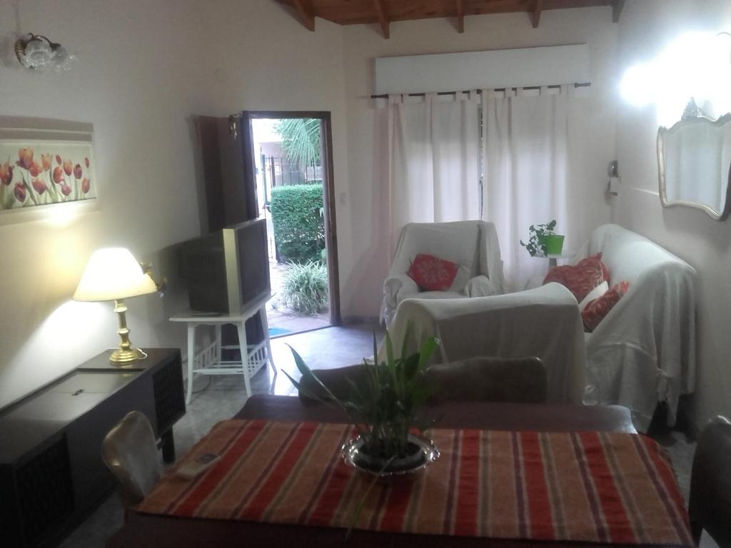 a living room with two chairs and a tv at Las Acacias De Santa Rosa in Santa Rosa
