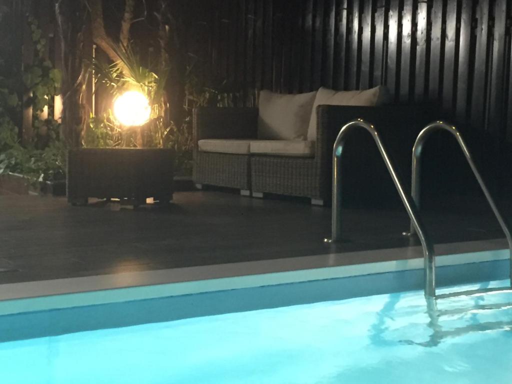 a swimming pool with two faucets next to a couch at Stelle Di Mari in Milan