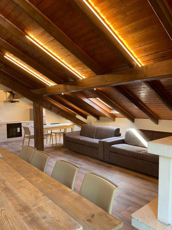 a living room with a long table and chairs at Seandre Holiday Apartments in Prada