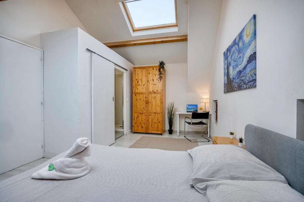 a bedroom with a bed and a skylight at COLIVING - Private Suite Bathroom - Toilet in Saint-Jean-de-Gonville