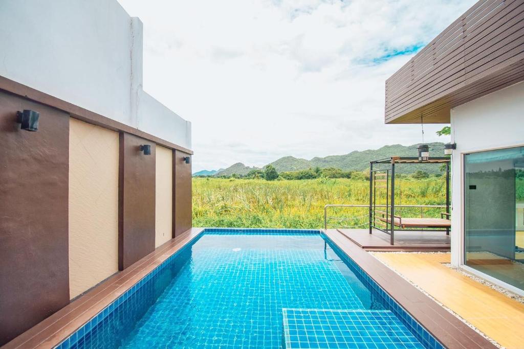 a swimming pool in the middle of a house at The Vista Pool Villa in Kanchanaburi City