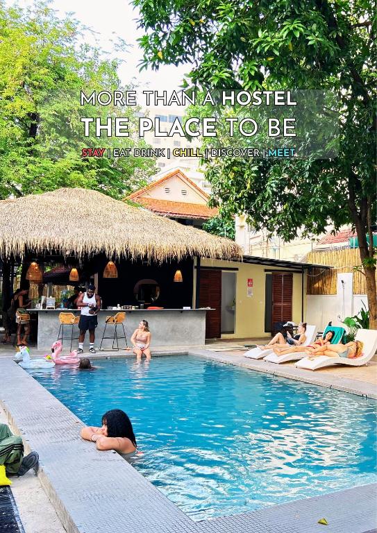 a group of people in a swimming pool at THE PLACE Hostel Phnom Penh in Phnom Penh