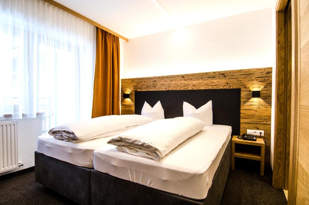 Posteľ alebo postele v izbe v ubytovaní Hotel Garni Persutt