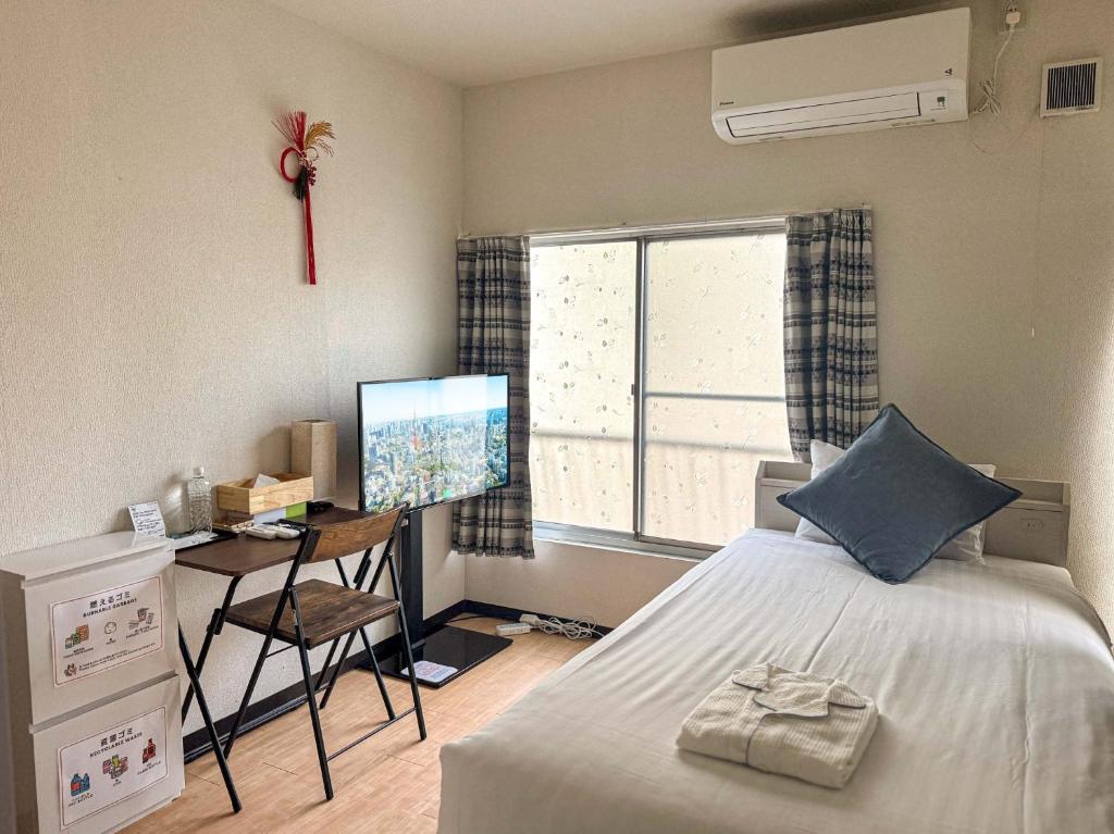 a bedroom with a bed and a desk with a computer at D Hotel - Vacation STAY 89642v in Tokyo