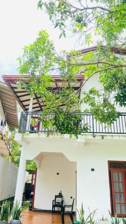 a view of the outside of a house with a balcony at Chami Leisure Home in Talpe