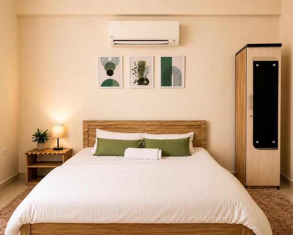 a bedroom with a large bed with a white comforter at Live Easy in Siliguri