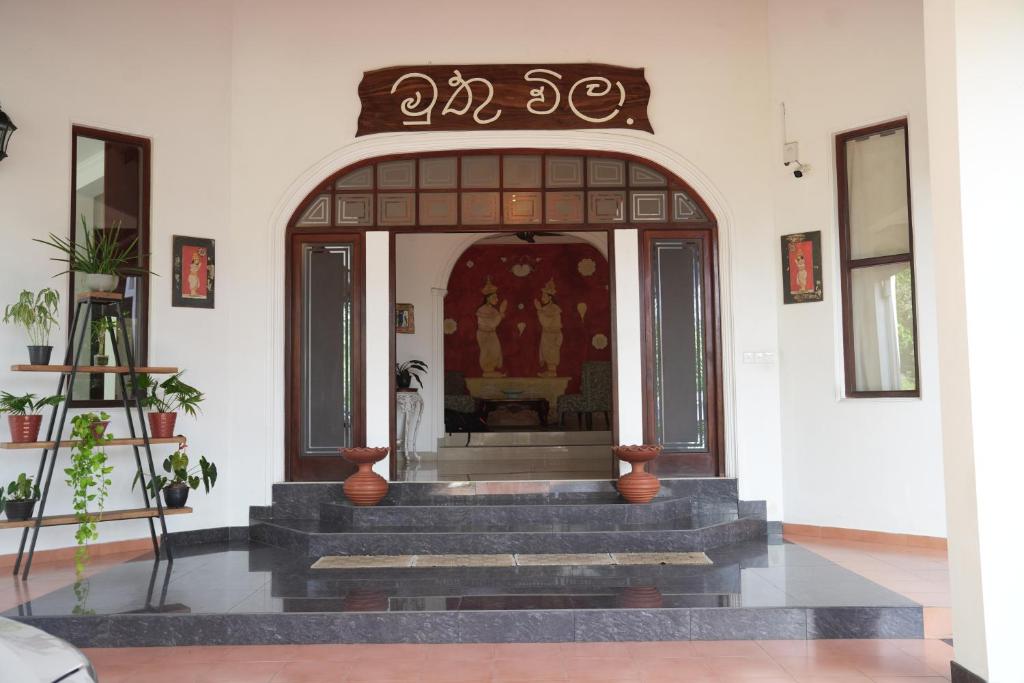 an entrance to a building with stairs in a room at Muthu Villa, Kandy in Nikawatawana