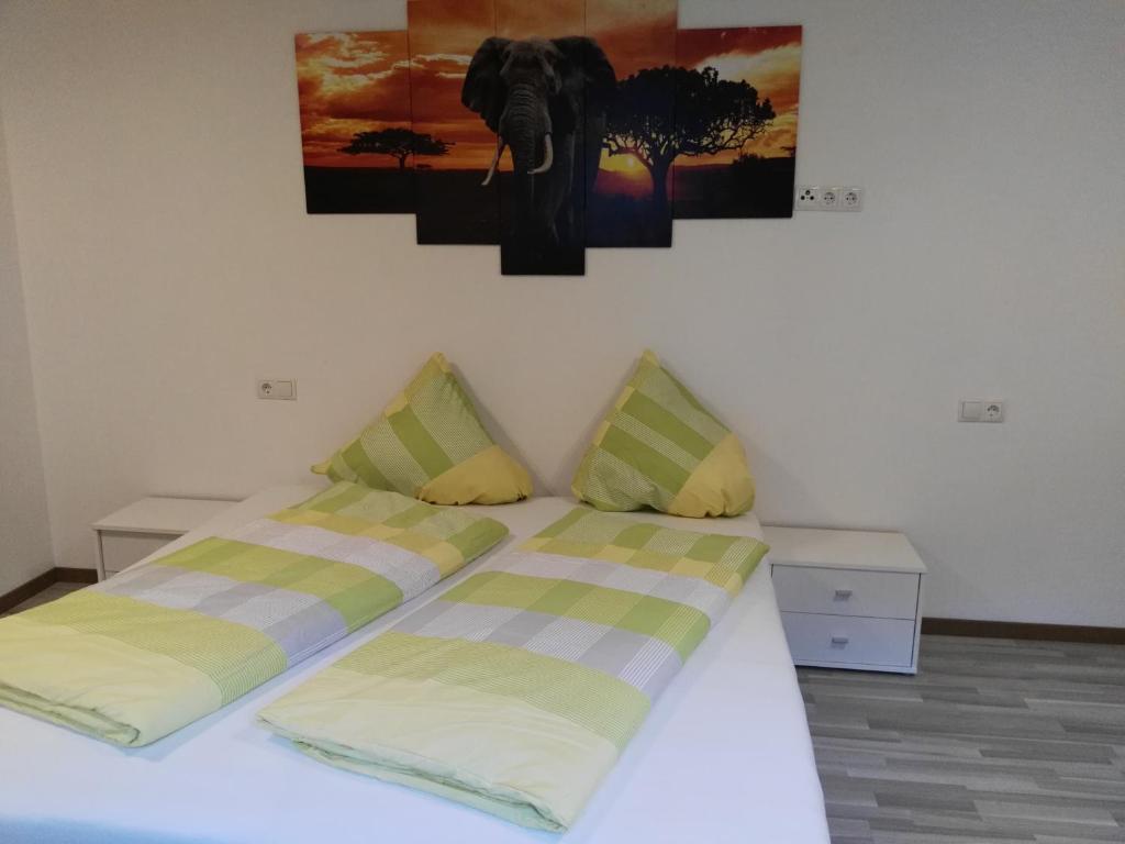 a bed with two pillows and a picture of an elephant at Ferienwohnung Mair in Umhausen