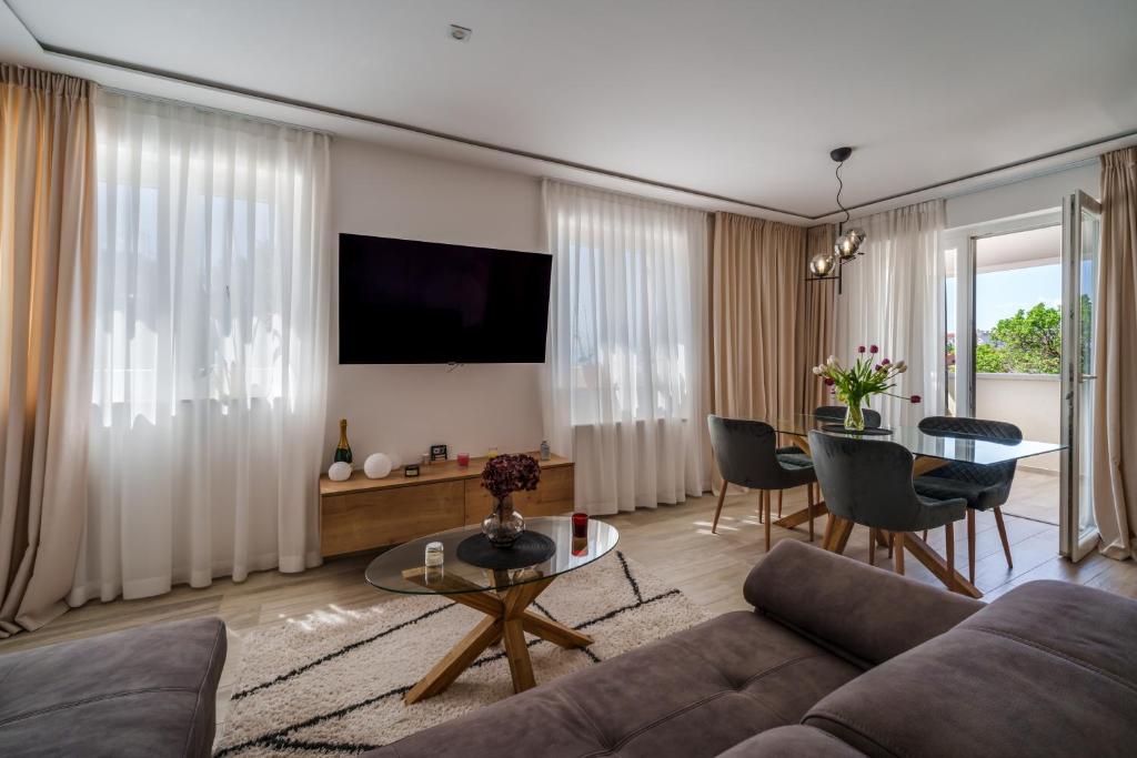 a living room with a couch and a table at Apartments Barbara Kraljevica in Kraljevica