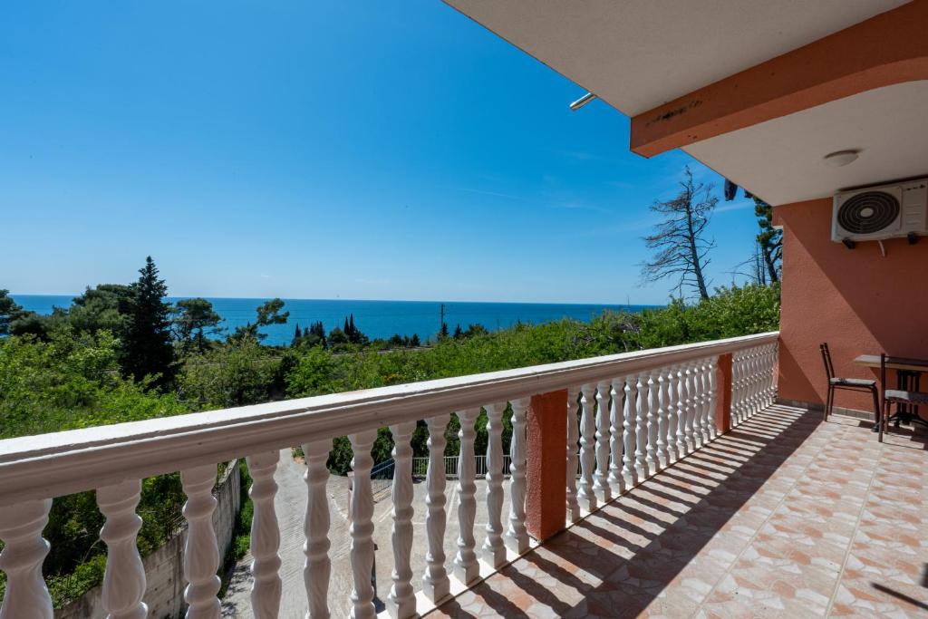a balcony of a house with a view of the ocean at Benelux Apartments Bar in Šušanj