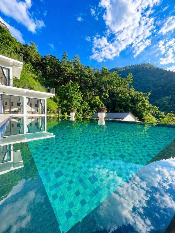 a pool of water in front of a house at Sam Hotel Lào Cai in Pu Chu Chay