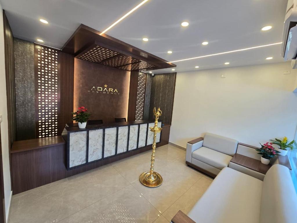 a living room with a lobby with a couch and a table at AdaraResidency in Trivandrum