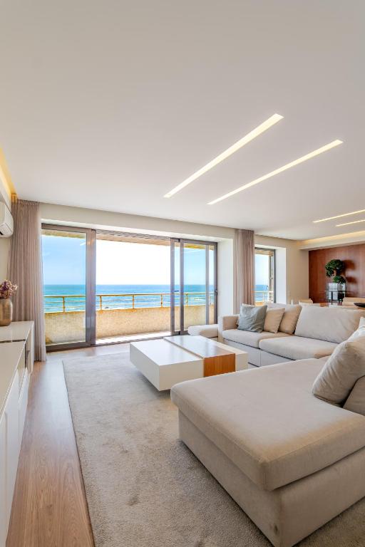 a living room with a view of the ocean at Beachouse Pvz - Seafront By Pomerania in Póvoa de Varzim