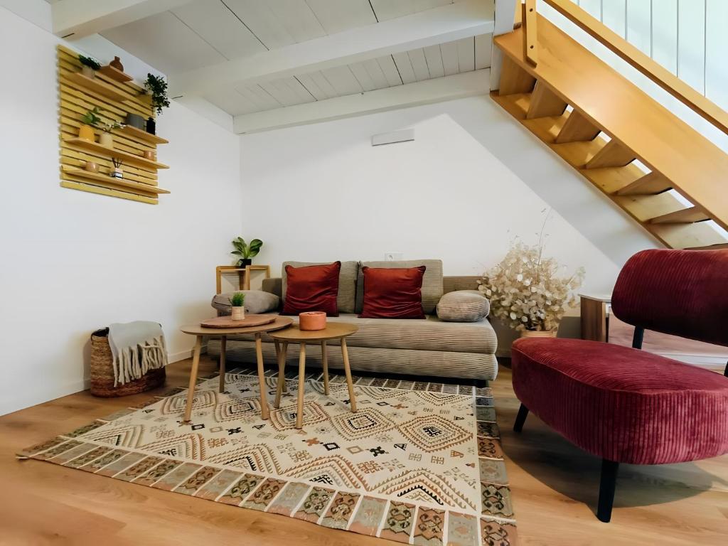 a living room with a couch and a table at Südsteirer Suite in Bad Radkersburg