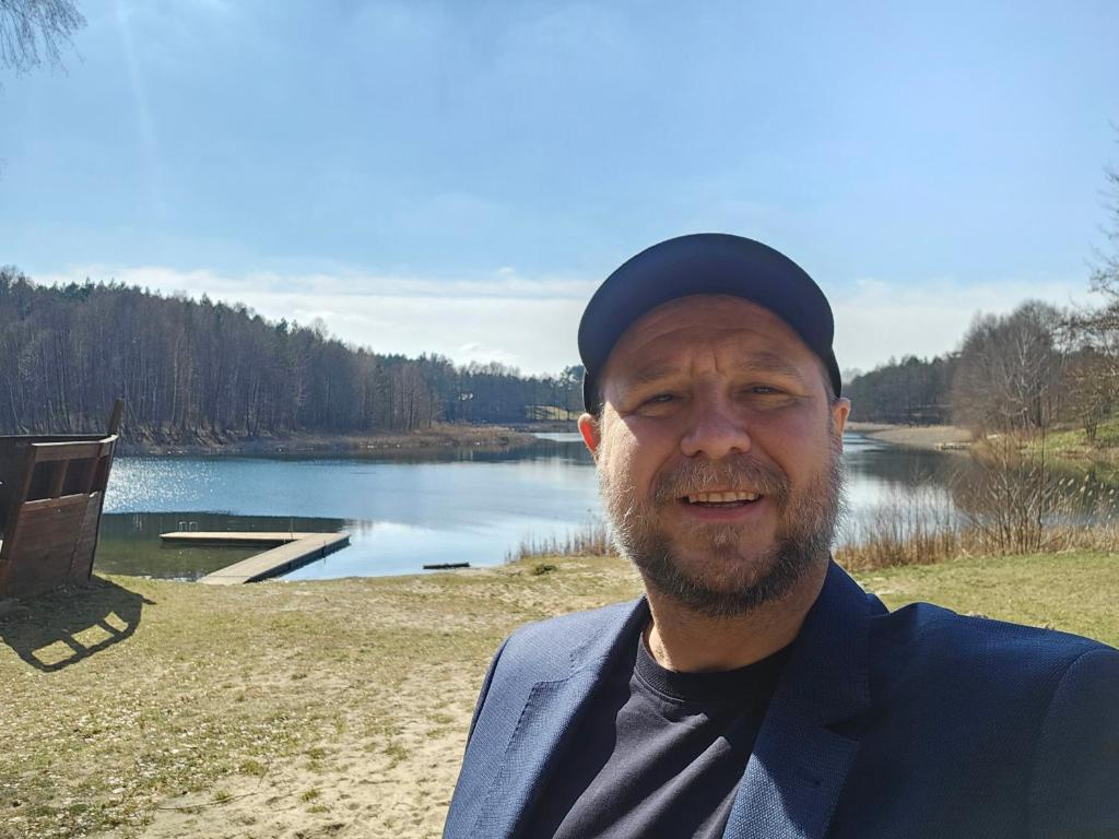 a man wearing a hat and a suit at Michal in Tleń