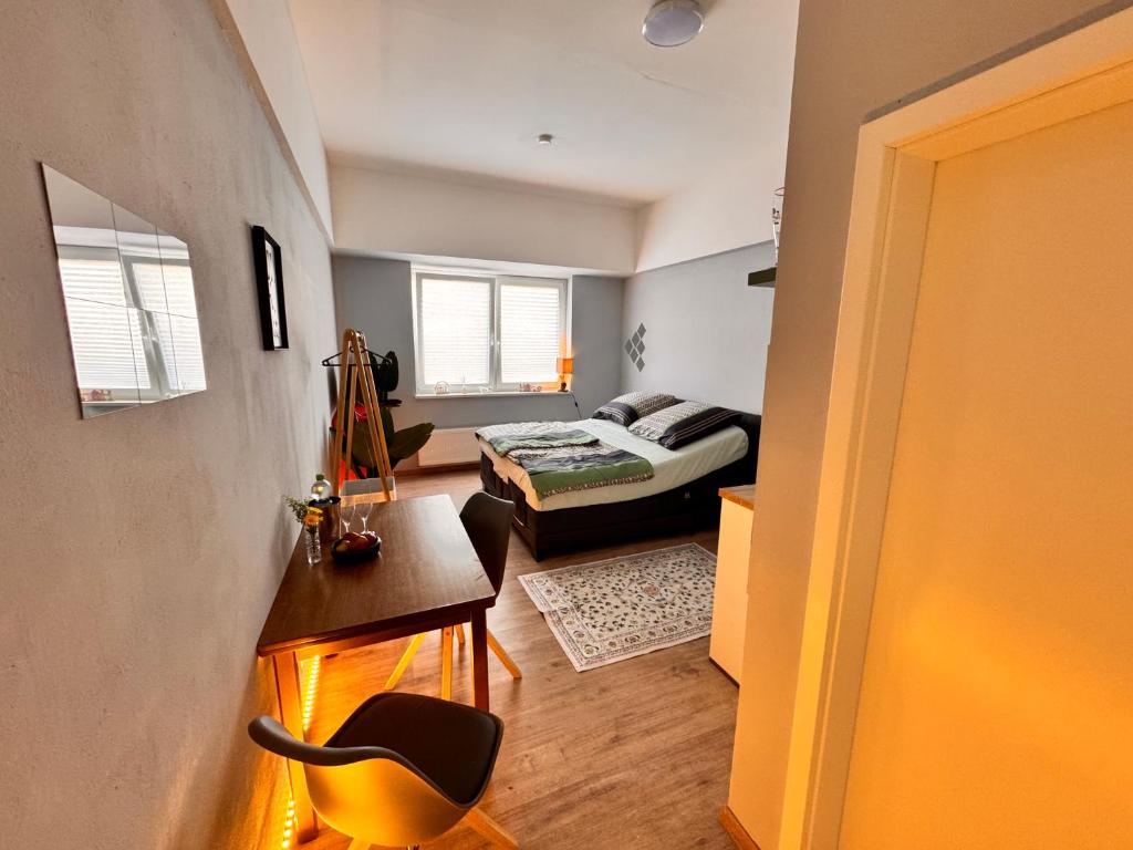 a bedroom with a bed and a desk and a table at Fuchsbau Komfort Zimmer in Nordhausen