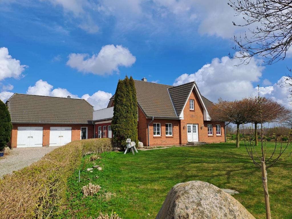a house with a grass yard in front of it at Ferienwohnung Morgenstern in Ausacker