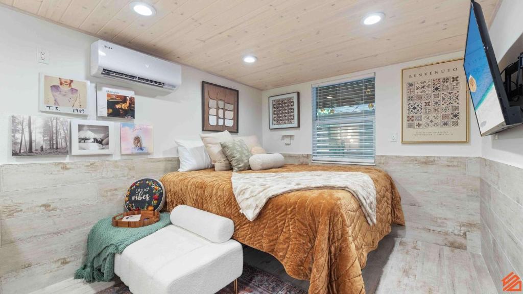 a bedroom with a large bed and a chair at Swiftie Suite Beach Getaway Studio in Santa Rosa Beach