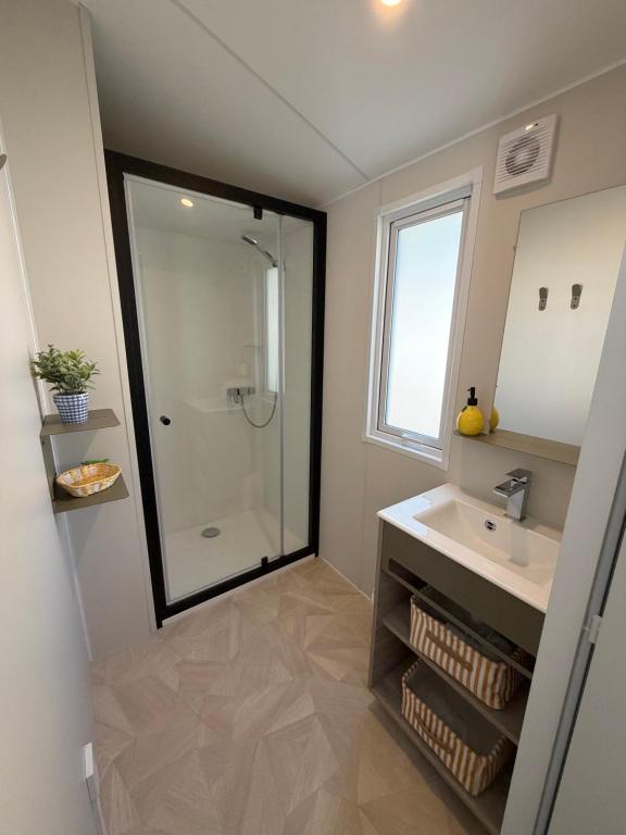 a bathroom with a sink and a glass shower at Bahia in Le Faulq