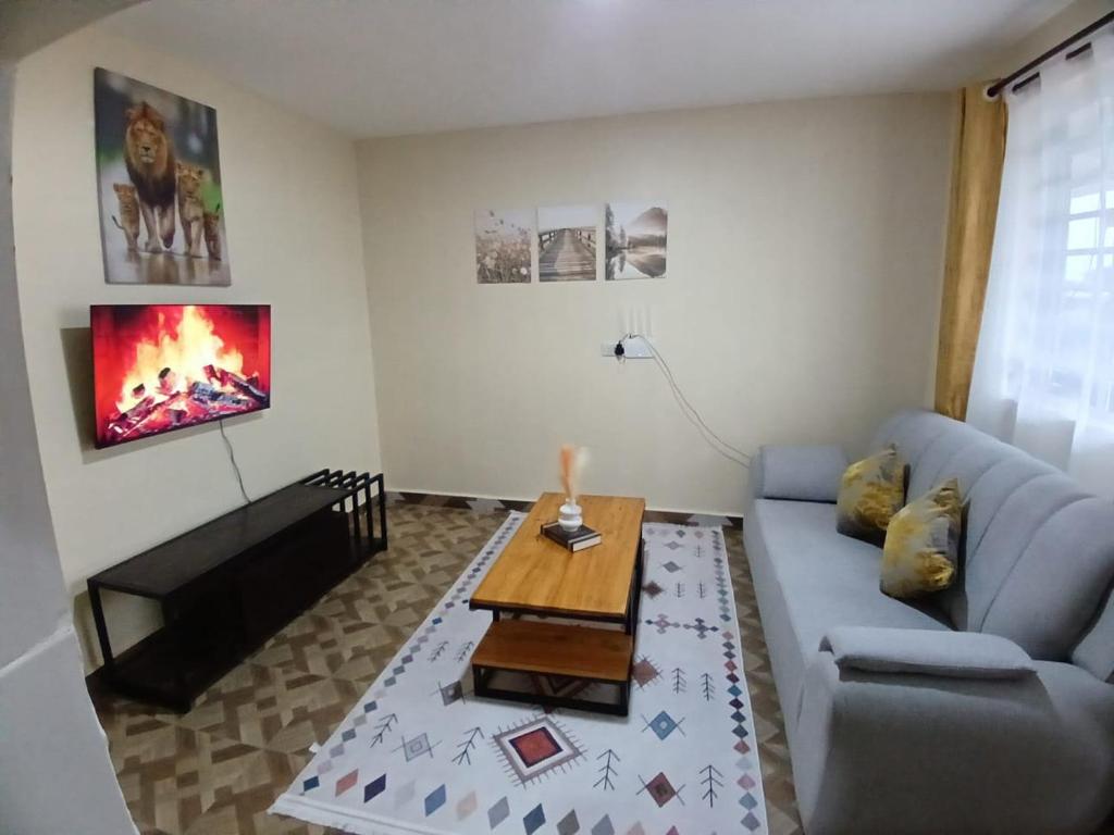 a living room with a couch and a table at Zaburi Homes in Kajiado