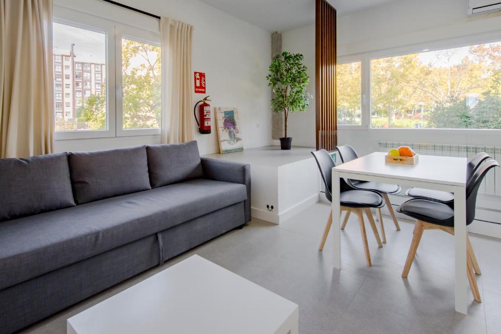 a living room with a couch and a table at Plata by Clabao in Madrid