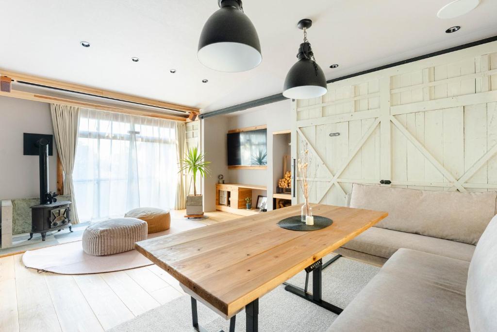 a living room with a wooden table and a couch at Cellar 88 in Sonogi