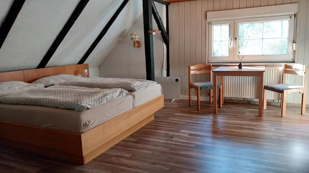 a bedroom with a bed and a table and chairs at Marienthal in Ingersleben
