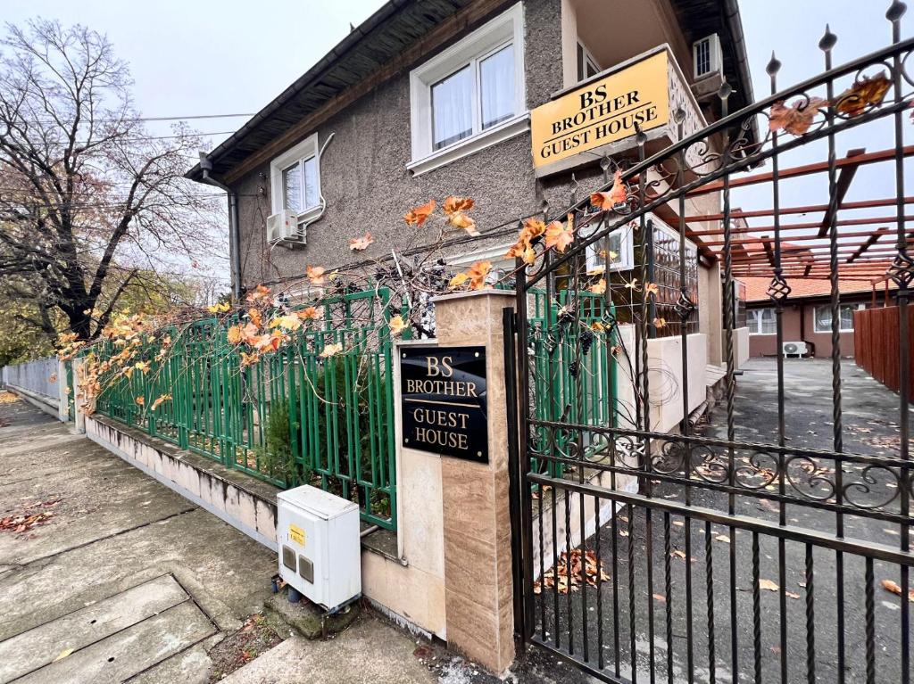 a gate to a guest house with a sign on it at BS Brother in Ruse