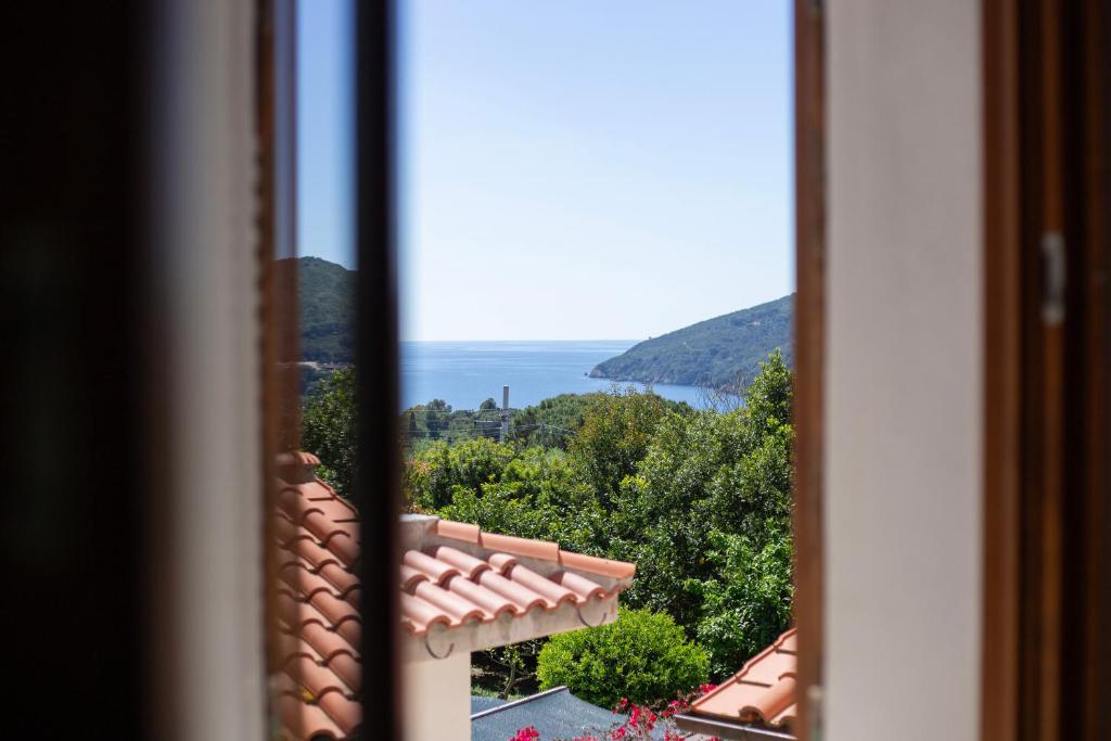 a view of the ocean from a window at Casa Martina by ElbaSummer in Lacona