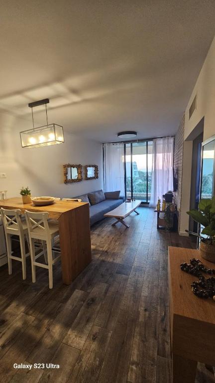a kitchen and living room with a table and a couch at Rona Suite in Caesarea