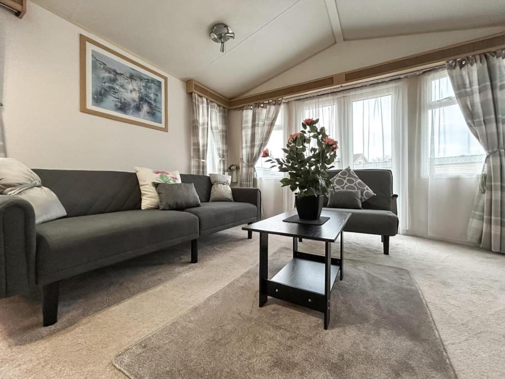 a living room with a couch and a table at The Ash in Angus