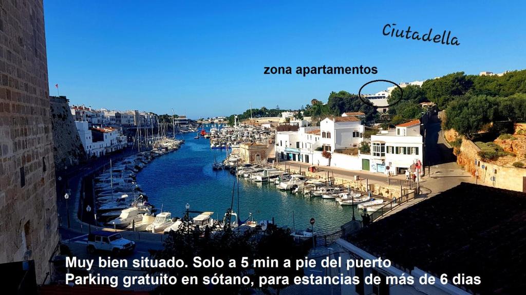 a river filled with lots of boats in a city at Apartamento Cala Busquets 6 pax in Ciutadella