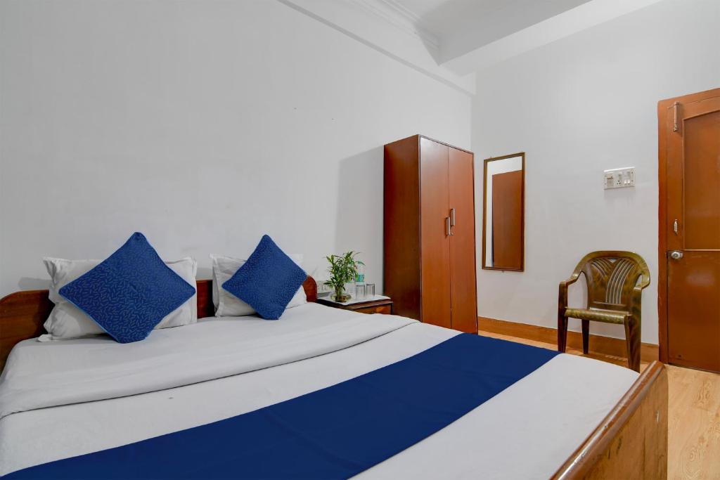 a bedroom with a large bed with blue pillows at Brill Rooms Near City Centre Metro Station in Salt Lake City