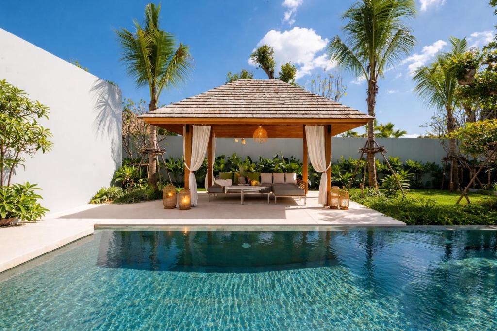 a gazebo sitting next to a swimming pool at Grand garden villa Free Airport Pickup from 7 days in Phuket