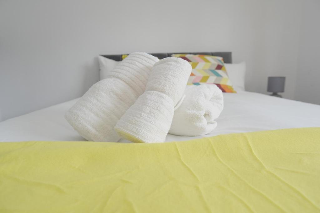 a group of rolled up towels on a bed at The Linwood Terrace in Eastwood