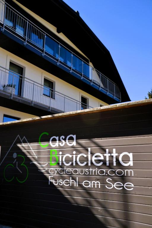 a sign on a wall in front of a building at Casa Bicicletta in Fuschl am See