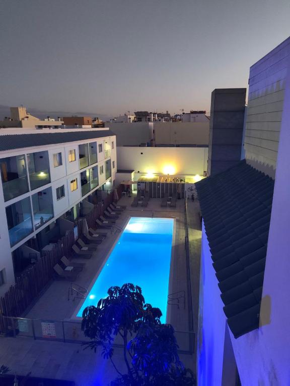 a pool on the side of a building at night at 51 E-scape Home in Corralejo