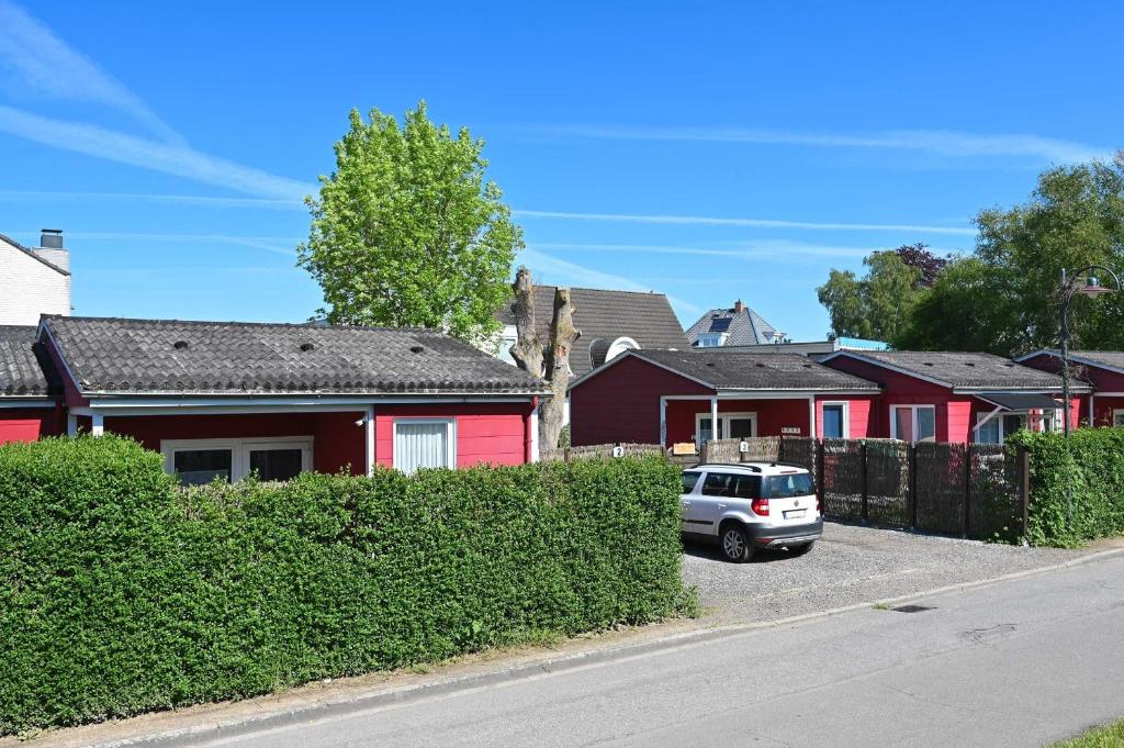 a car parked in front of a row of houses at Bungalow Nebel Nr 3 in Kellenhusen