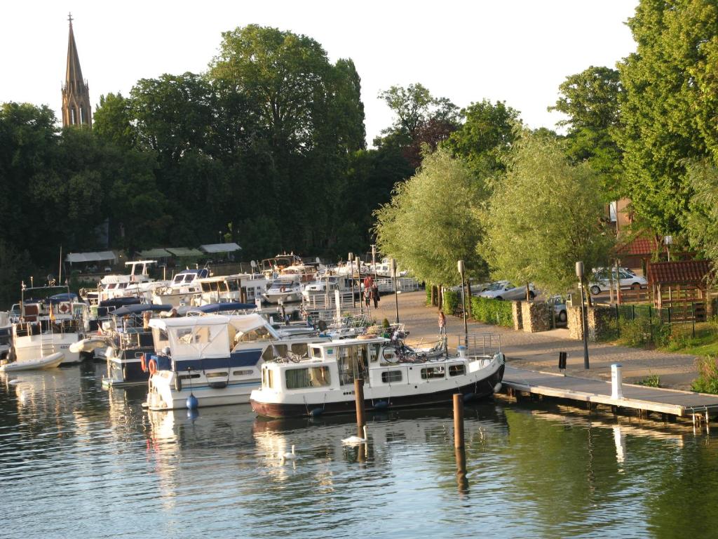 a group of boats docked at a marina at Les Chambres de l&#39;Ile in Metz