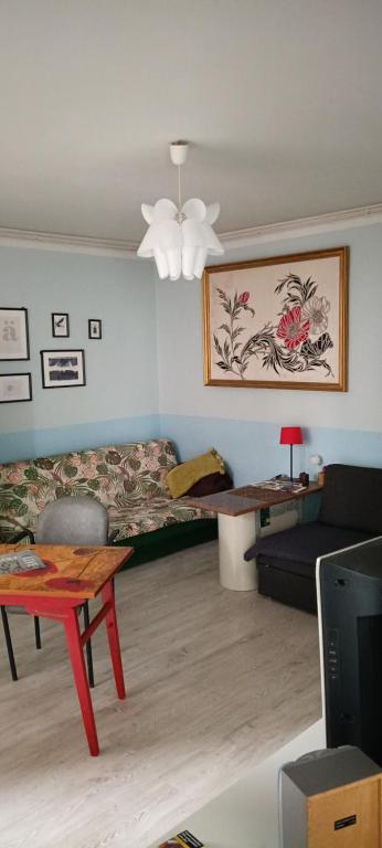 a living room with a couch and a table at Kawalerka in Gdynia