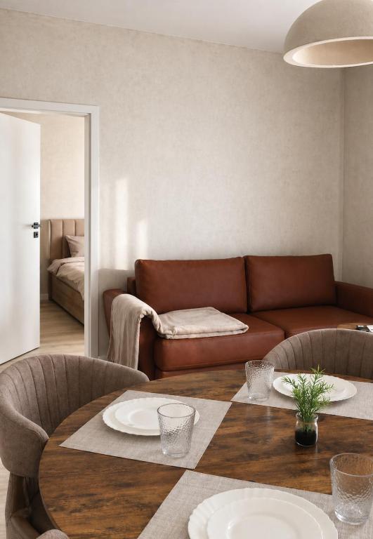 a living room with a couch and a table at Simba Apartments Baile Felix in Baile Felix