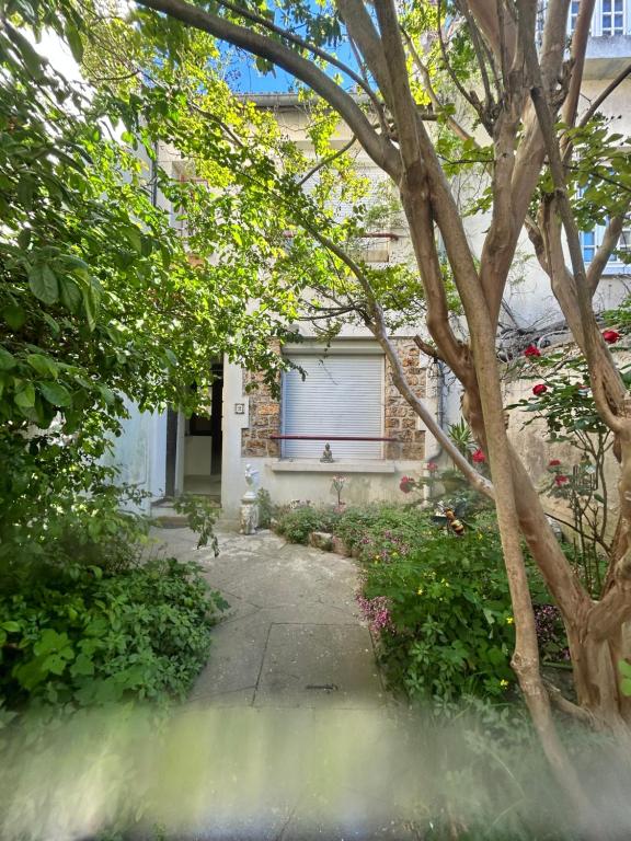 a driveway leading to a house with a garage at F3 au grenier d'une maison in Massy