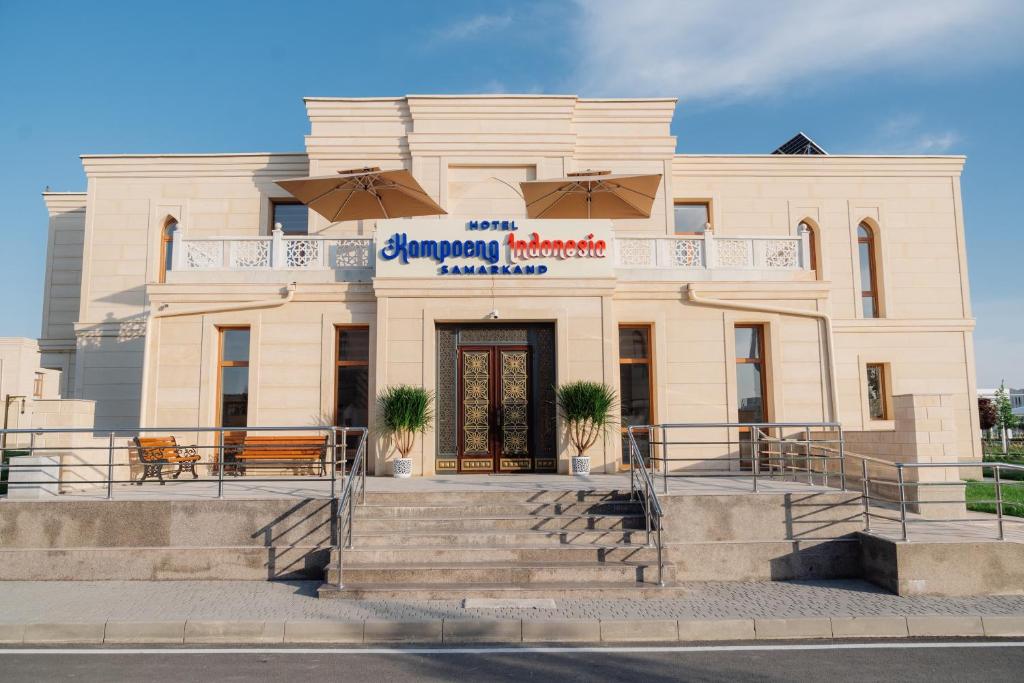 a building with a sign on the front of it at Kampoeng Indonesia Hotel in Khodzha-Ismail