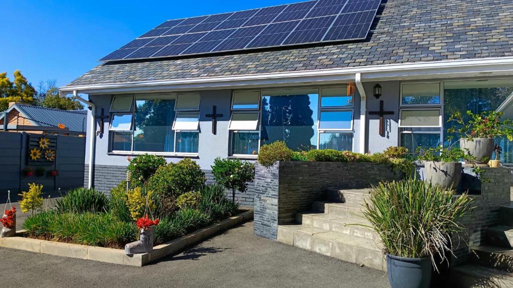 a house with solar panels on the roof at Utopia Guest House in Alberton