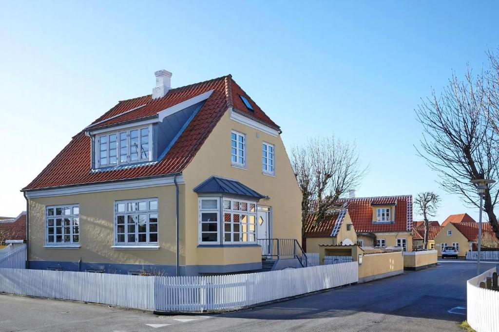 a yellow house with a red roof at Spacious House In Skagen in Skagen