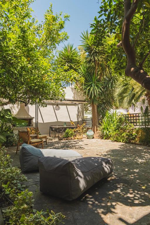a large bean bag chair in a yard with trees at Joyful Secret Garden Residence Downtown by 8essentially in Chania