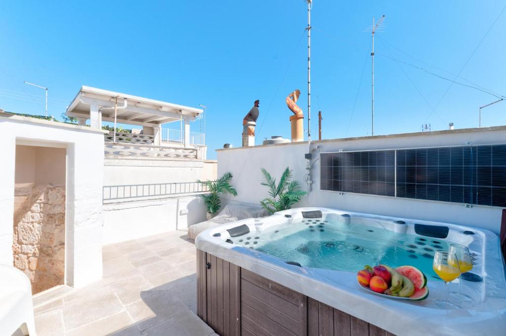 a hot tub with fruit in it on a patio at Ostuni Luxury Stay - 2 Jacuzzi in Ostuni