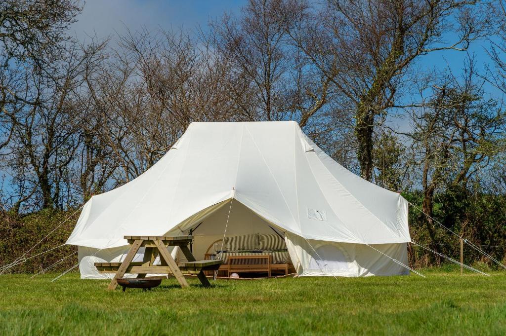 a large white tent in a field of grass at Boscoppa Farm-Emperor Tent No2 in Trethurgy