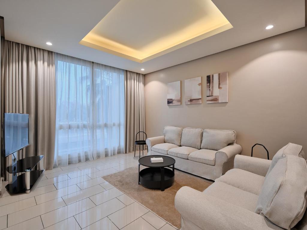 a living room with two couches and a tv at Hamad - Salmiya -Family only in Kuwait