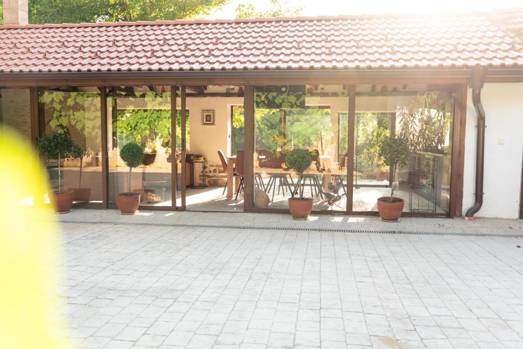 a screened in porch with potted plants and a patio at Casa Mila in Belish